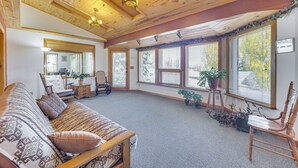 A cozy room with a wooden ceiling, a sofa, a chair, and large windows with blinds. - Mtn-view Colorado Haven! 32 Mi to Royal Gorge Park (Cotopaxi)