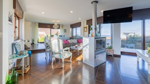 Una sala de estar moderna con un sofá, sillones, una mesa de centro y una chimenea.