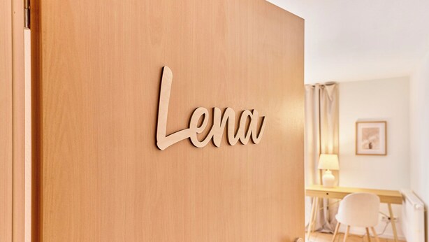 A wooden door with a nameplate reading "Lena." - Lena Your break (Buchen)