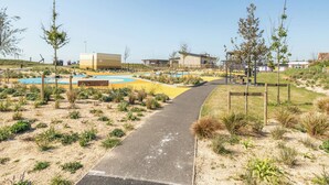 A pathway leading to a pool area with a building in the background. - Marine Court Second-floor Double Bedroom With Bathroom (Littlehampton)