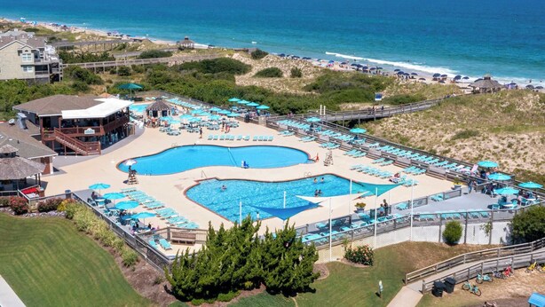 A resort with a large pool, beach access, and a view of the ocean. - Villa in Corolla Light with Views, Hot Tub & More! (Corolla)