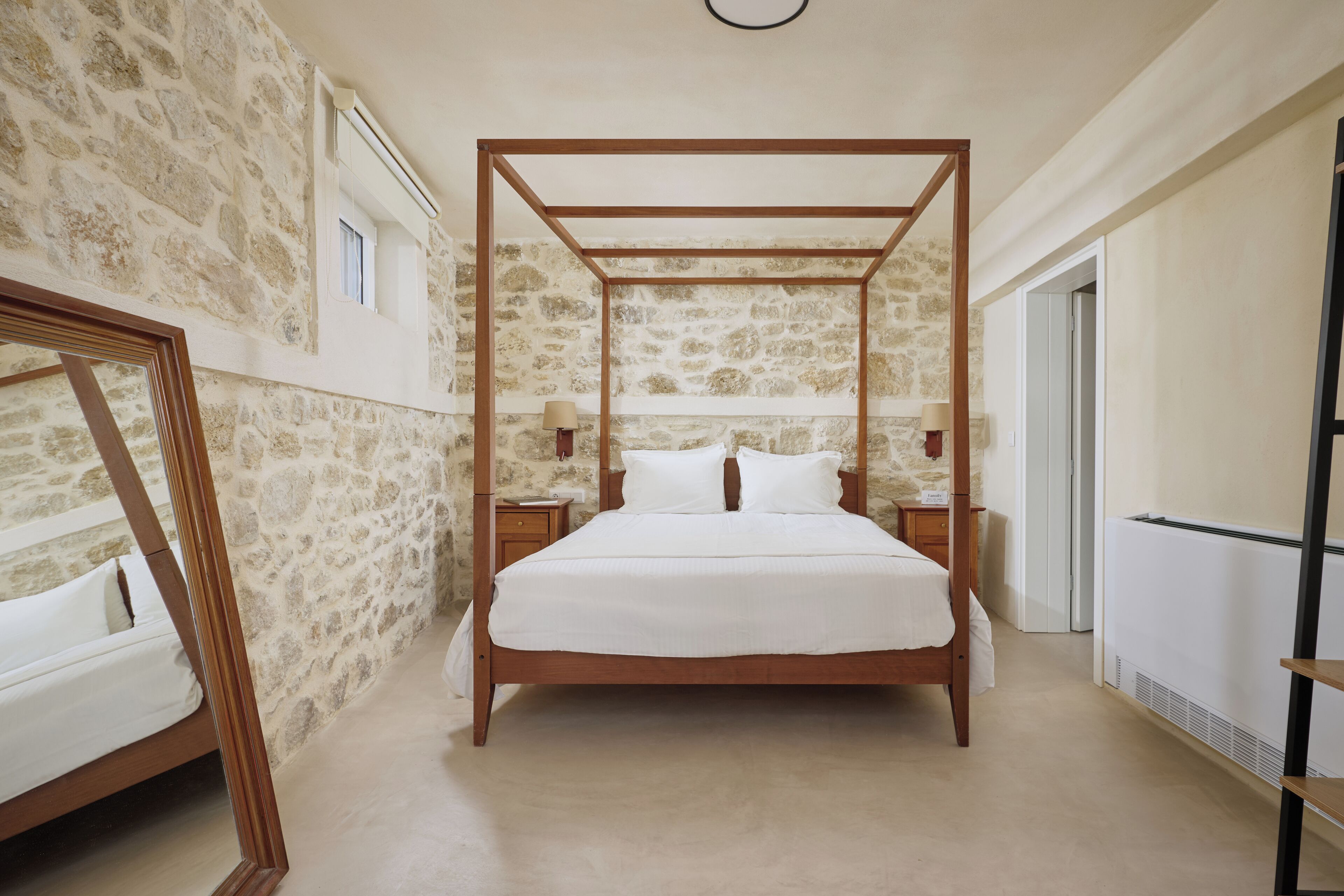 romantic master with a four-poster bed & stunning stone walls, a serene retreat
