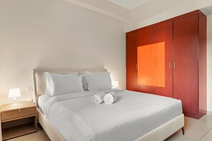 A bedroom with a bed, nightstands, a wooden wardrobe, and a window. - FIRST CLASS | 2BR | Spectacular Sea View (JBR)