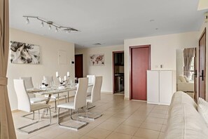 A modern living room with a dining area, a kitchen, and a red door. - FIRST CLASS | 2BR | Spectacular Sea View (JBR)