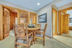 A dining area with a wooden table and chairs, a vase, and a framed picture on the wall. - CURRENTLY BEING REMODELED FOR THE 2026/2027 SEASON! NEW PHOTOS COMING SOON! (Deer Valley)