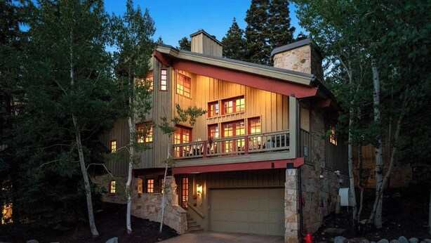 A two-story house with a stone foundation, a balcony, and a garage. - CURRENTLY BEING REMODELED FOR THE 2026/2027 SEASON! NEW PHOTOS COMING SOON! (Deer Valley)