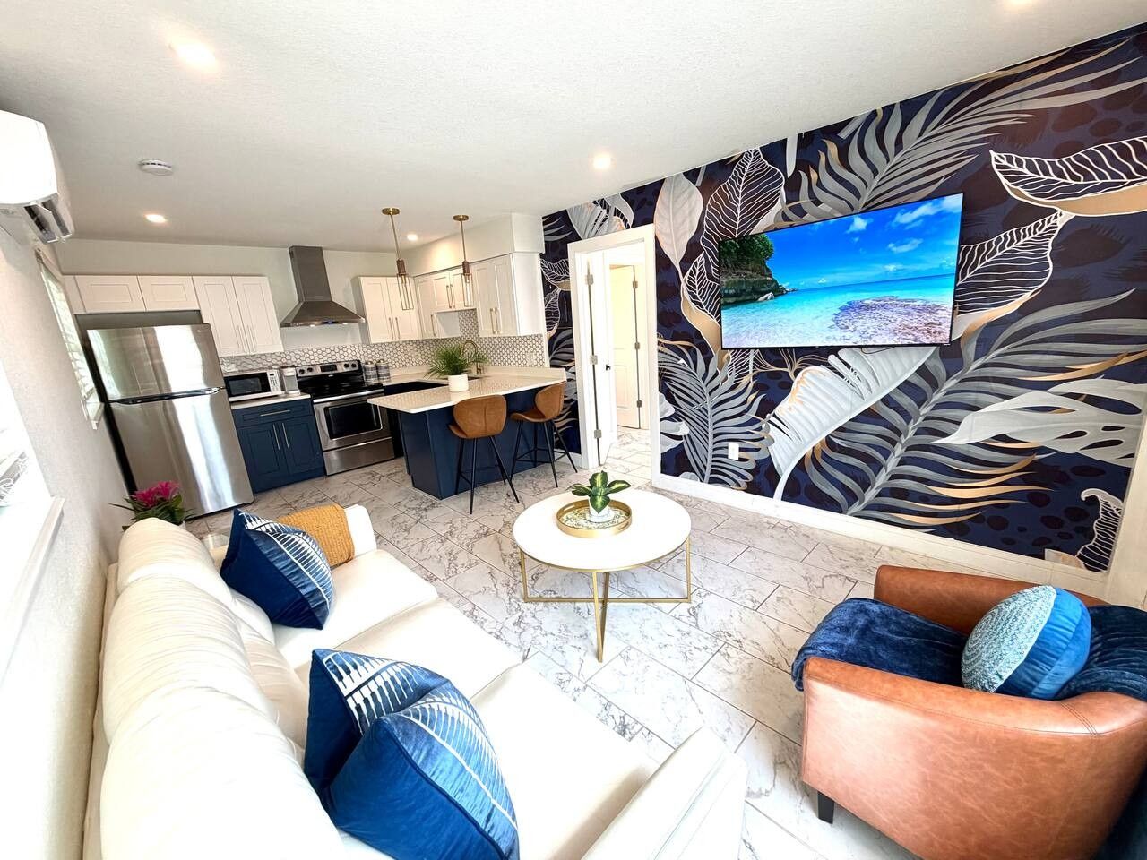 A modern living room with a sofa, armchairs, and a coffee table.