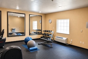 A gym with exercise equipment, mirrors, a clock, and a window. - Comfortable Family Suite w/ Kitchenette Near Shopping & I-12 Corridor - 2 Units (Denham Springs)
