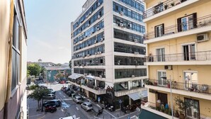 A multi-story building with a modern architectural style, featuring large windows and balconies. - PSV Mitropoleos  (Thessaloniki)