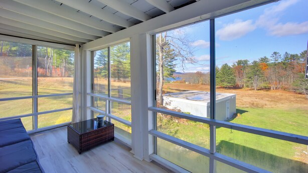 A room with large windows, a wooden ceiling, and a view of a grassy area with trees. - Lake-View Spofford Apartment w/ Shared Dock! (Spofford)