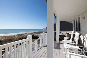 A wooden deck with white railings overlooking a beach. - Angel's Rest, 5 BR, 5.5 BA, Oceanfront with Game Room (Emerald Isle)