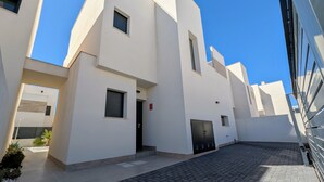 A modern building with a flat roof, a small window, and a door. - Villa 'R-58 Luxury New Build' with Private Pool, Terrace and Wi-Fi (Los Montesinos)