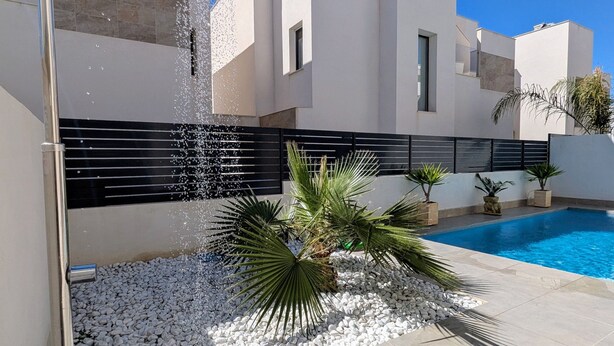 A modern outdoor pool area with a shower, white walls, and a clear blue sky. - Villa 'R-58 Luxury New Build' with Private Pool, Terrace and Wi-Fi (Los Montesinos)