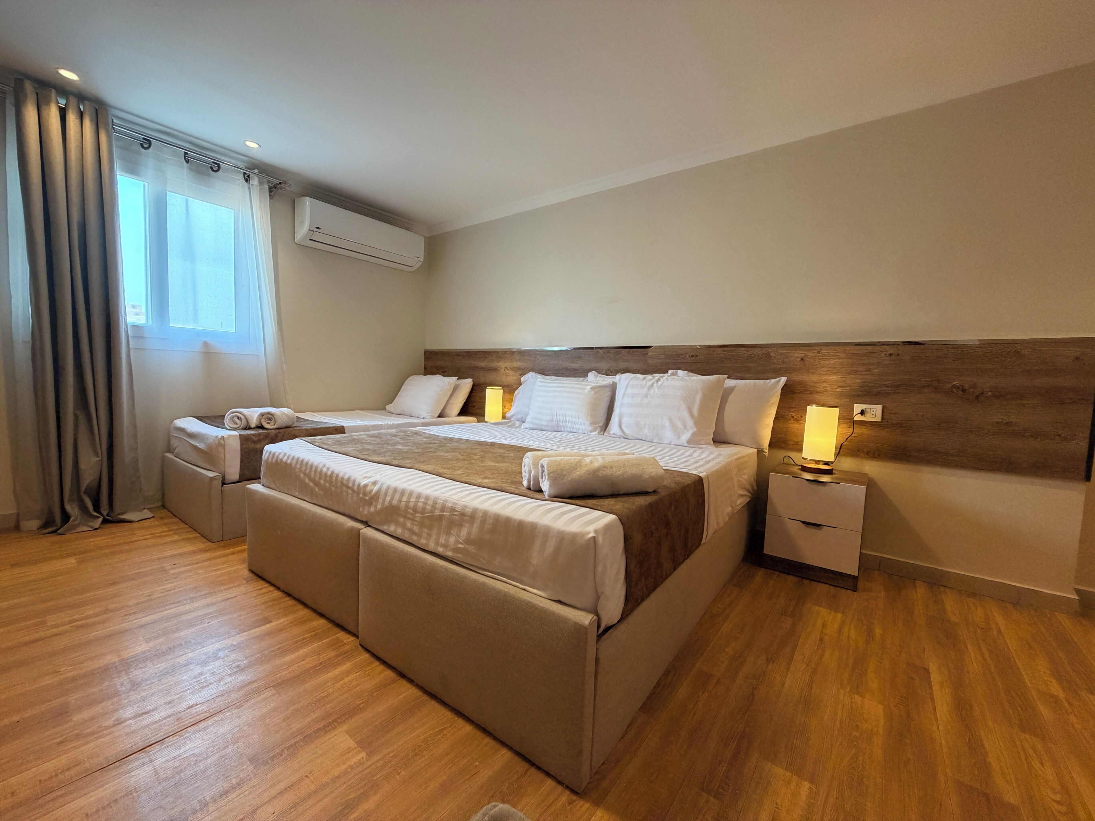 Deluxe Triple Room, Patio, City View | Laptop workspace, blackout drapes, soundproofing, iron/ironing board