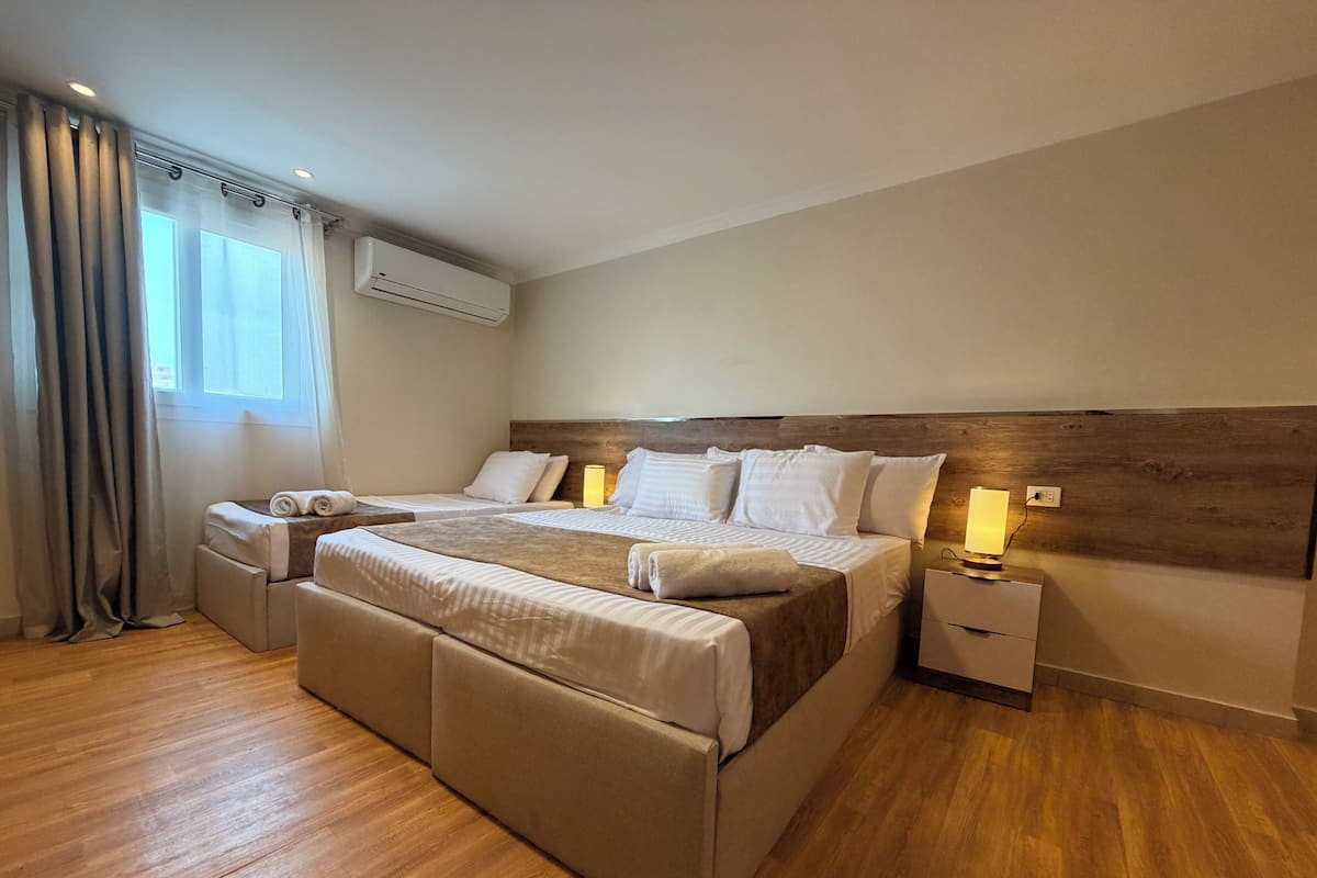 Habitación triple Deluxe, patio, vista a la ciudad | Espacio para trabajar con laptop, cortinas blackout y insonorización