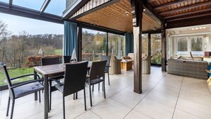 A covered patio with a dining table and chairs, a sofa, and a pool table. - Panorama Holiday Home Sorpesee, 120 sqm, Lake View, Private Terrace & Wi-Fi (Sundern)