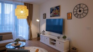A modern living room with a sofa, coffee table, TV, and decorative items. - Belgrade Waterfront Lux  (Belgrade)