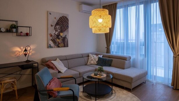 A modern living room with a sofa, armchair, and coffee table. - Belgrade Waterfront Lux  (Belgrade)