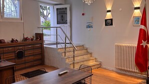 A modern kitchen with a dining area, a staircase, and a flag. - Disa Elite istanbul  (Istanbul)