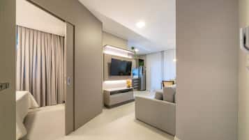 Deluxe Apartment, Lanai, City View | Living room | 50-inch Smart TV with digital channels