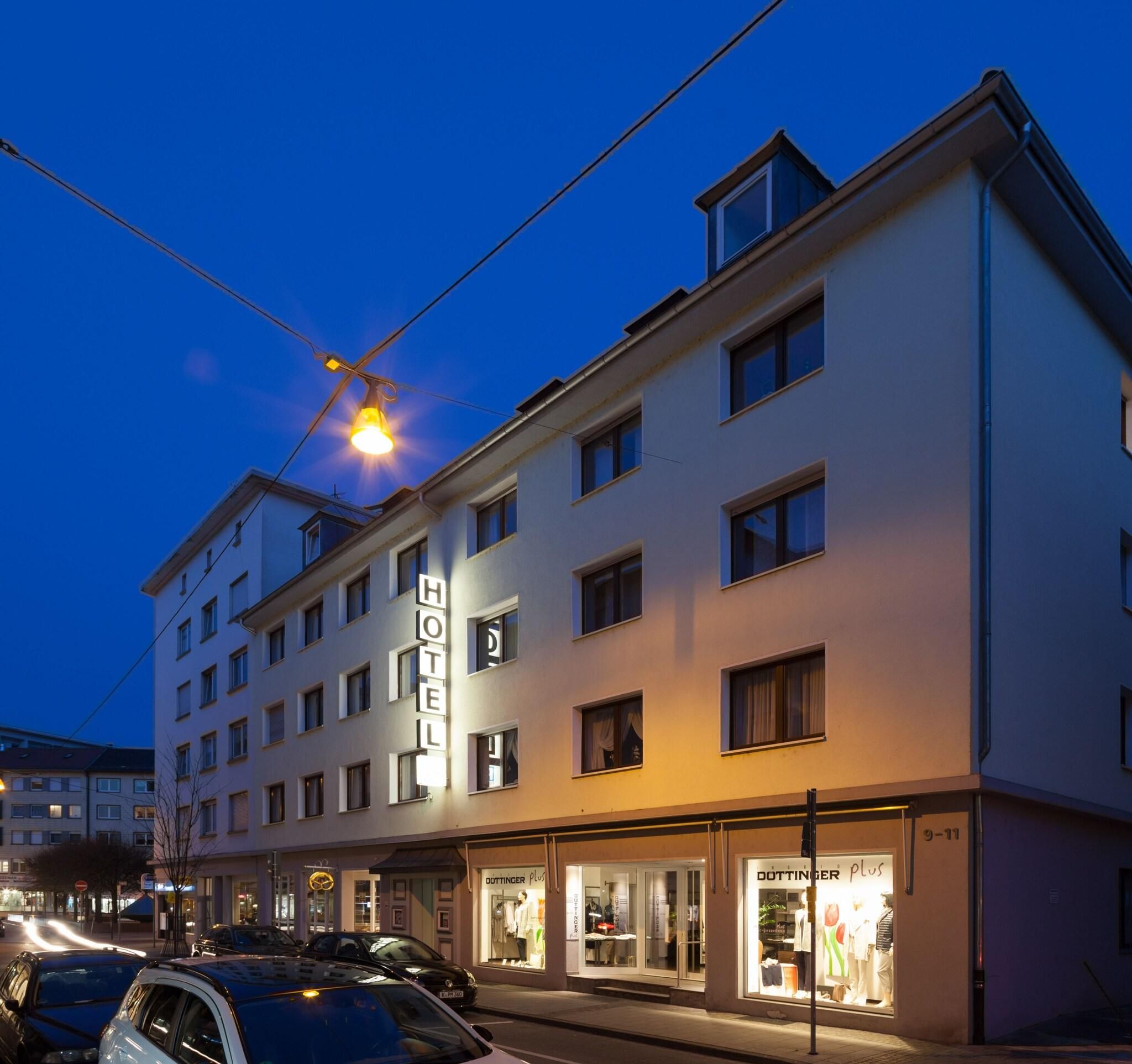 A multi-story hotel with a visible ground-floor boutique store.
