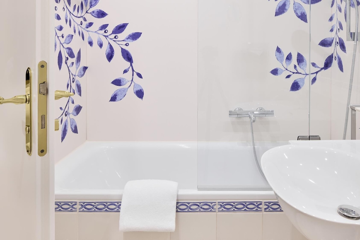 A bathroom with a bathtub, a sink, and a shower.