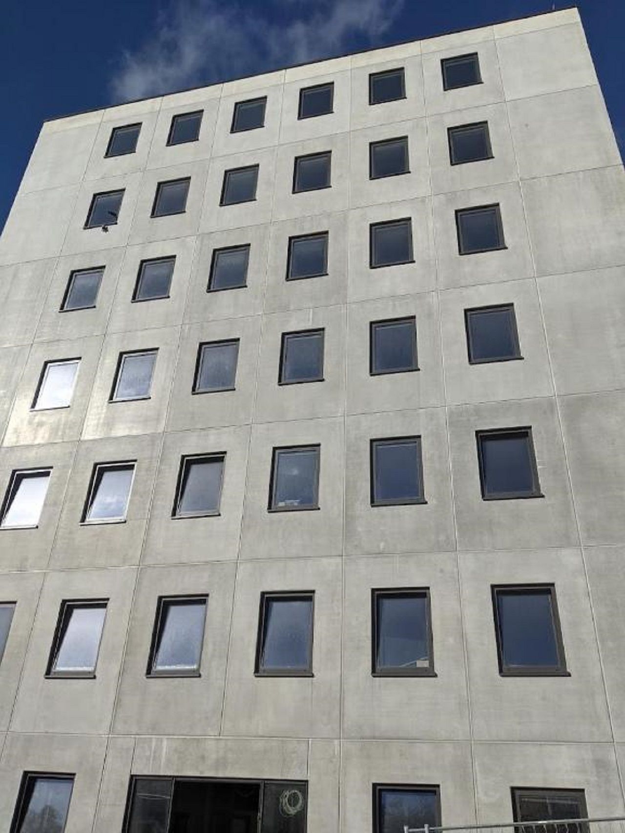 A modern building with a grid of windows and a flat facade.
