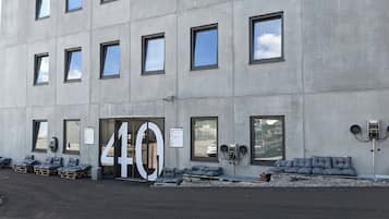 A building with a large '40' sign, multiple windows, and outdoor seating with cushions.