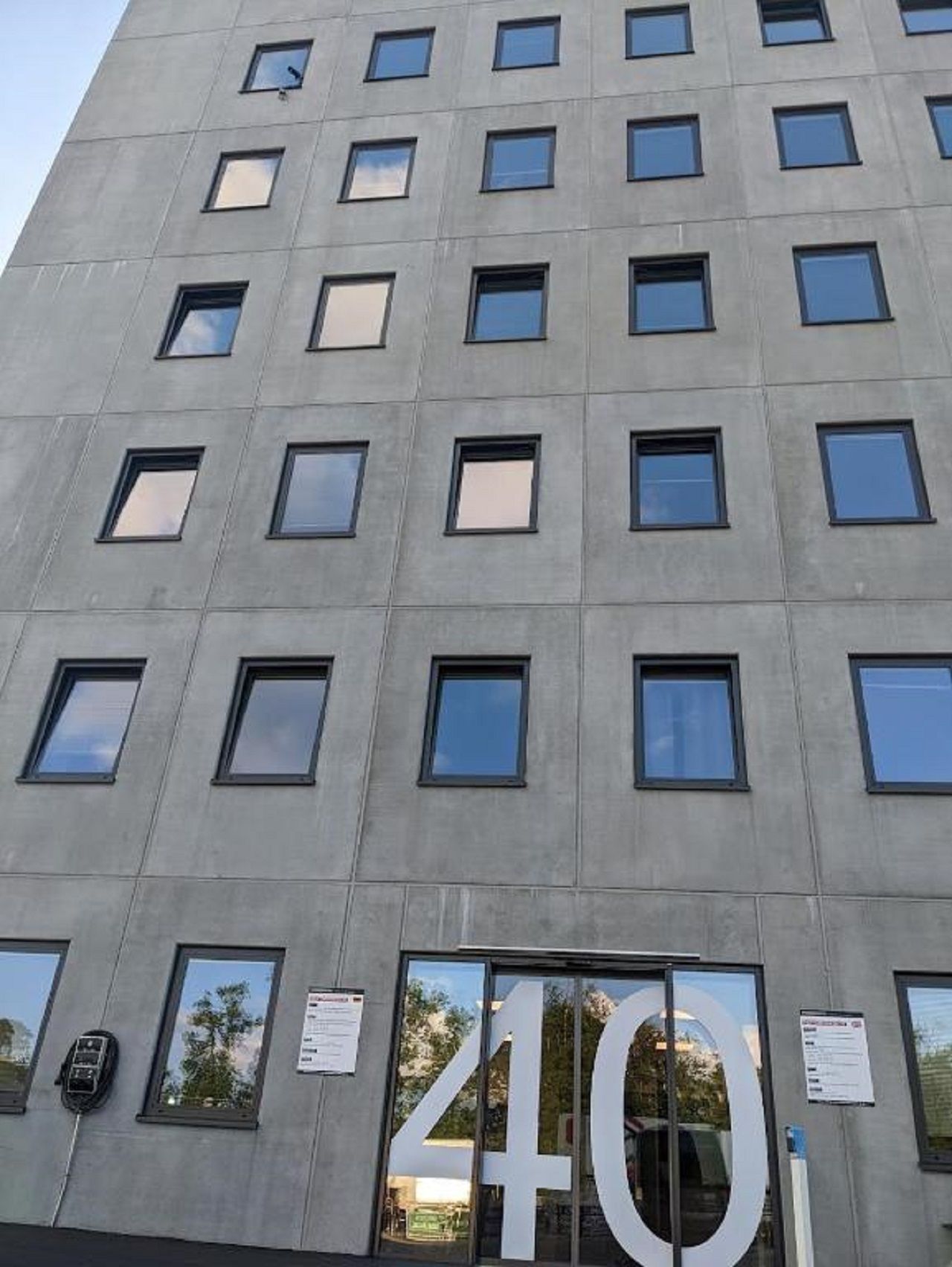 A modern building with a large number '40' sign, multiple windows, and a glass entrance.