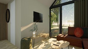 A modern living room with a large window, a flat-screen TV, a wooden bench, a round coffee table, and a sofa with a red cushion. - Cozy 6-person Lodge by the Fishing Pond (Balkbrug)