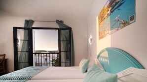 A bedroom with a bed, a view of the sea through an open window, and a painting on the wall. - Bimbolla Apartaments (Sant Lluis)