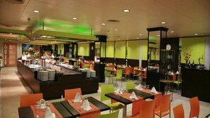A restaurant with multiple dining tables and chairs, a buffet area, and a counter with food items. - H Top Secret-roulette 4 Santa Susanna (Santa Susanna)