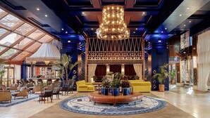 A spacious lobby with a central seating area, a bar, and a large chandelier. - Hacienda Del Mar Melia Collection (Estepona)