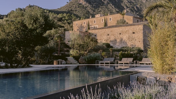 A stone building with a pool and lounge chairs. - Es Raco D Arta, a Member of Design Hotels (Arta)