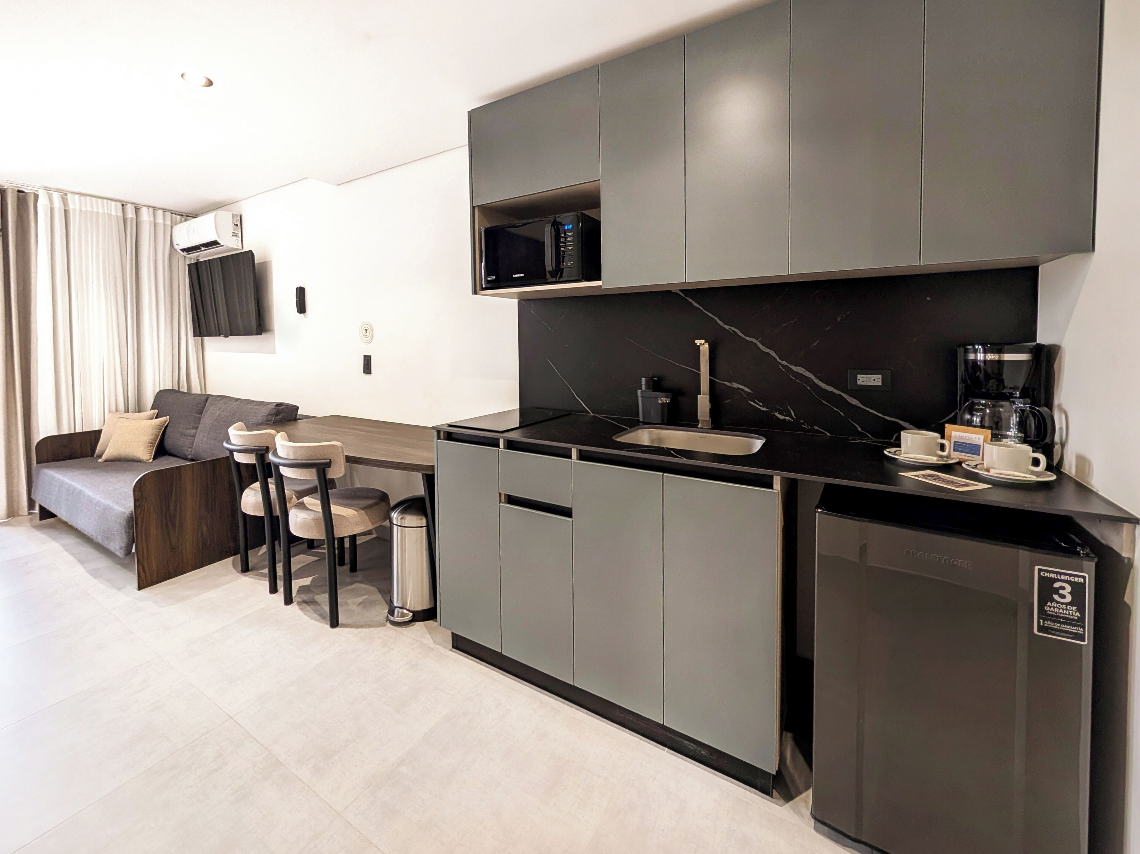 A modern kitchen with a built-in microwave, a coffee machine, and a dishwasher.