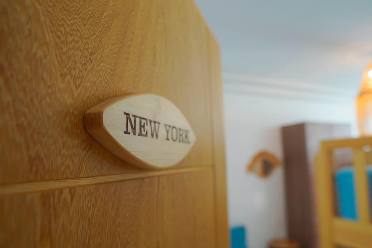 A wooden door with a sign that reads 'NEW YORK'.