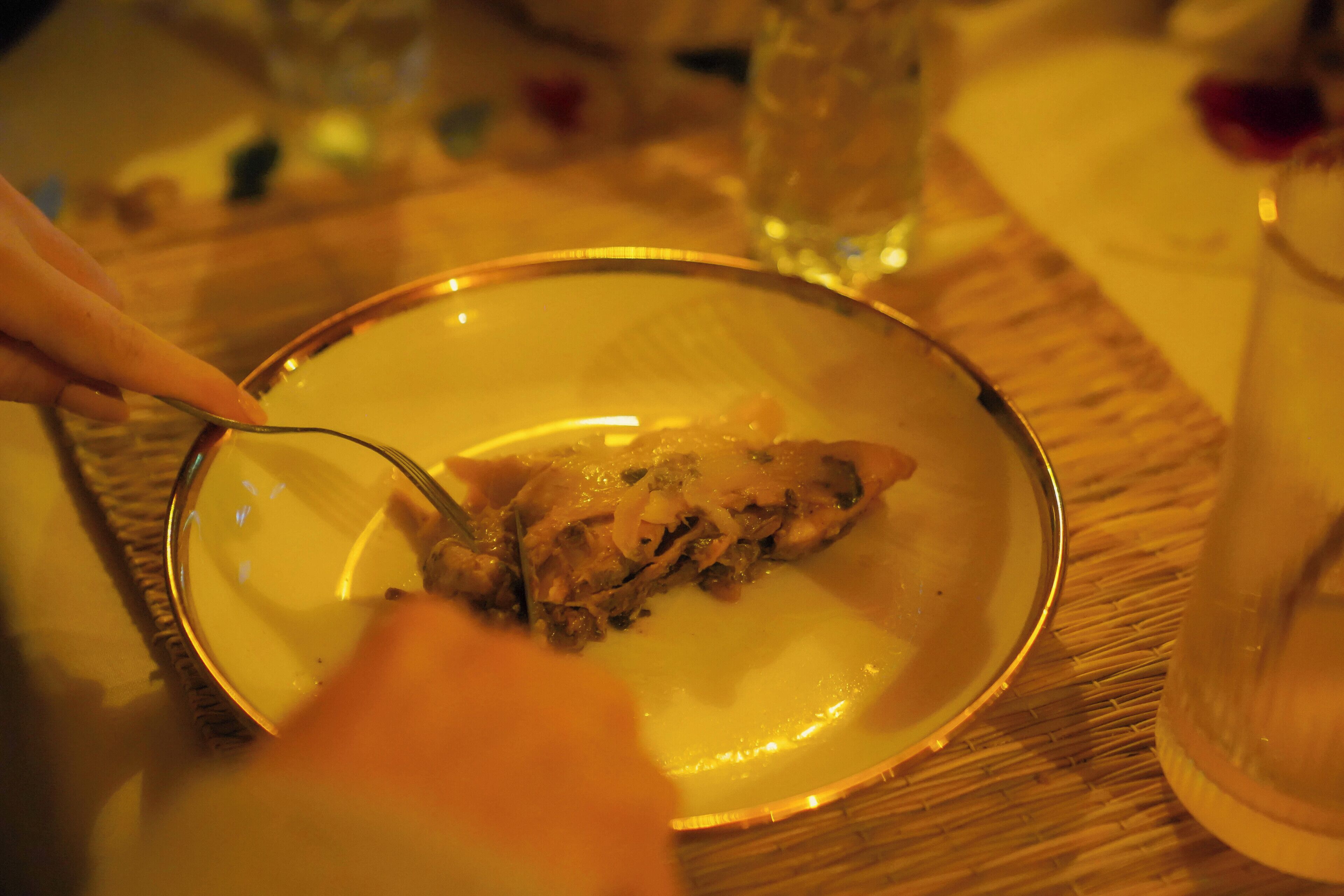 A dining table with a plate of food and a glass of water.