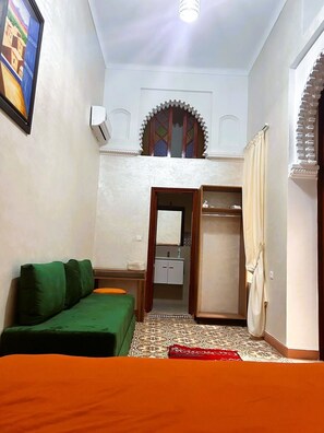 Deluxe Triple Room, Patio, Courtyard View | Living area