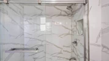 Shower, hair dryer, towels, shampoo
