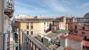 A multi-story building with balconies, a rooftop terrace, and a clear sky. - Antica Dimora Deluxe with Balcony, Wi-Fi and Air Conditioning (Napoli)