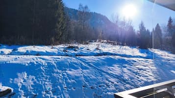 A snowy landscape with a clear sky and a building in the foreground.
