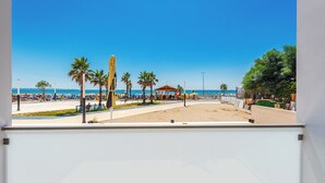 A beach view with palm trees, umbrellas, and a gazebo. - Adriatic Seaview Suites by PS (Durrës)