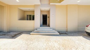 A modern building entrance with a central staircase leading to an elevator. - Adriatic Seaview Suites by PS (Durrës)