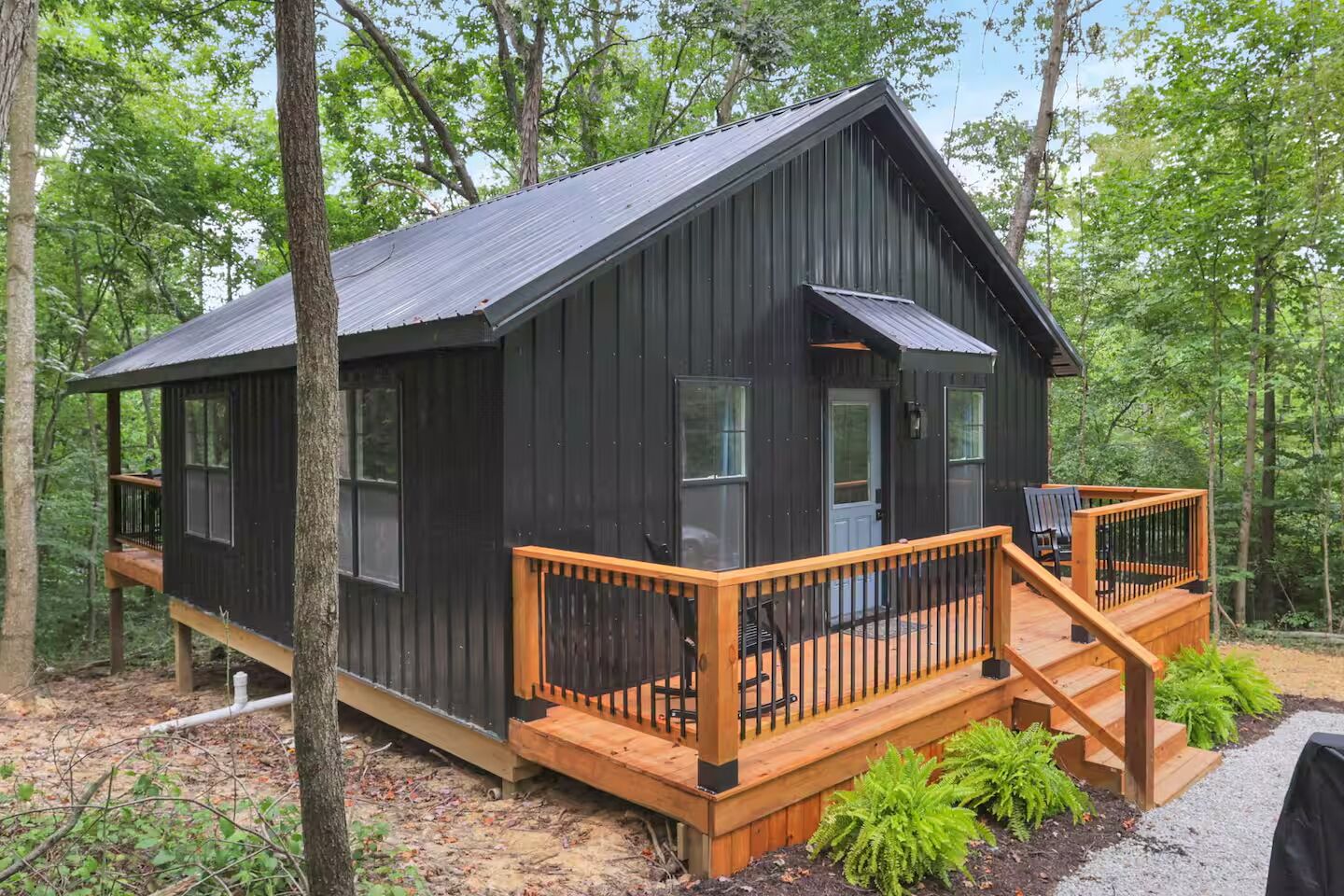 A cabin with a wooden deck and a small porch area.