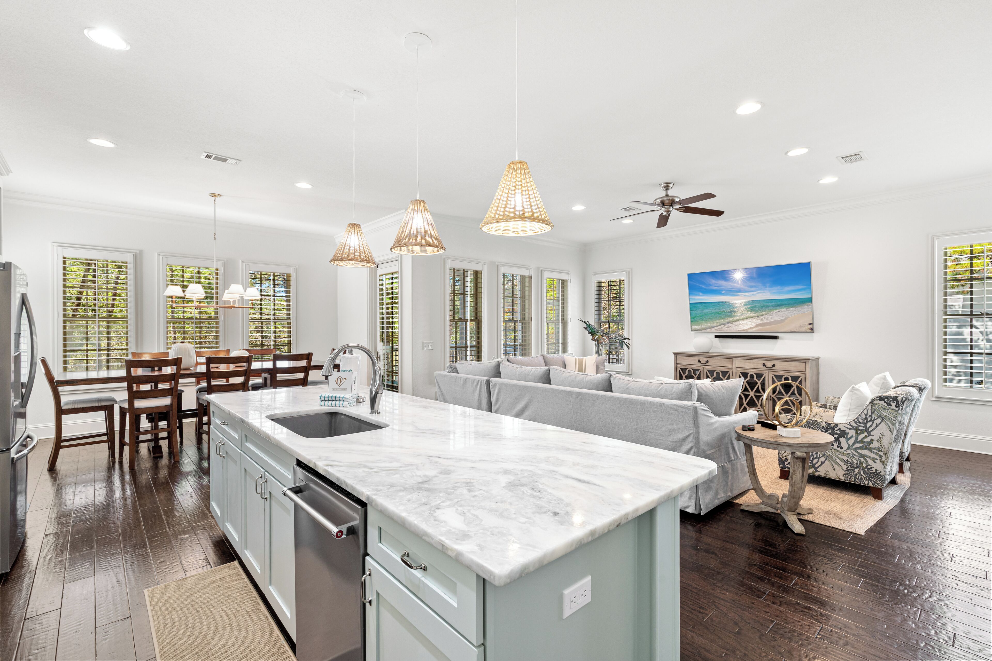 Gather around your spacious kitchen island while natural light streams through plantation shutters, creating the perfect spot for morning coffee or evening conversations.