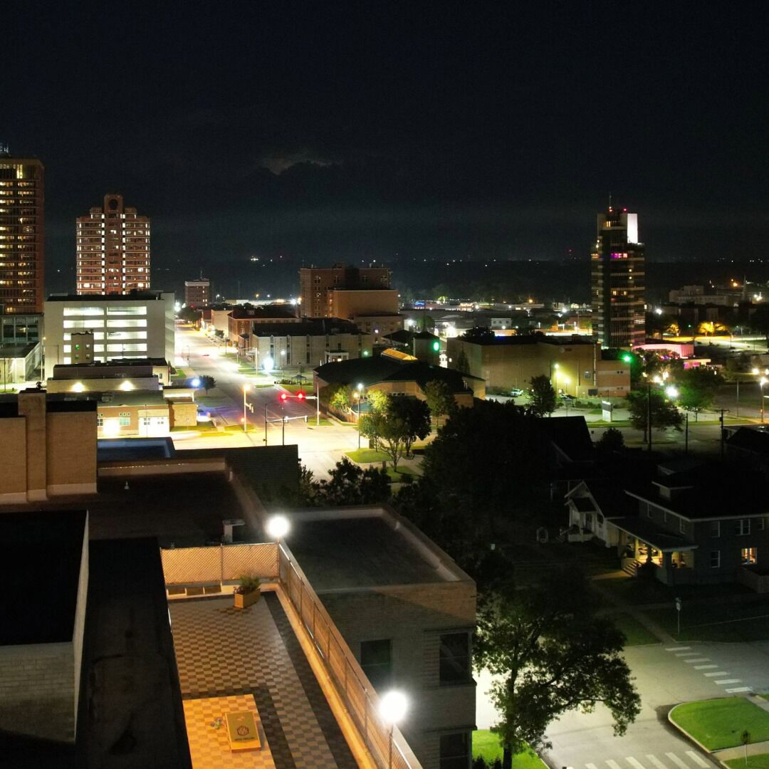 A nighttime cityscape with illuminated buildings and streets.