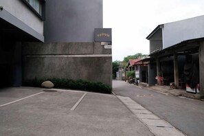 A narrow street with a building labeled 'TERON' on the left, a storefront on the right, and a clear sky above. - Teduh Simatupang (South Jakarta)