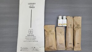 A luxury touch room slipper set with a white box and four brown paper bags. - Rome Jubilee Stays 2 (Rome)