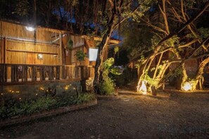A wooden building with a porch, surrounded by trees and a gravel path. - Trang An Ecorest Resort & Spa (Hoa Lu District)