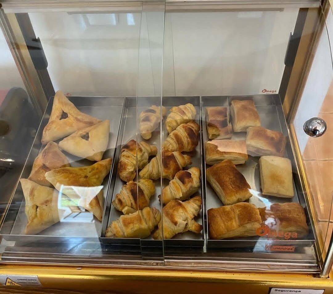 A bakery display case with various baked goods, including croissants and pastries.